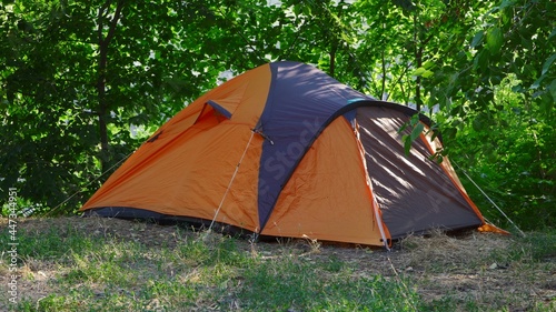 Tourists tent located in the forest. Hiking, outdoor activities.