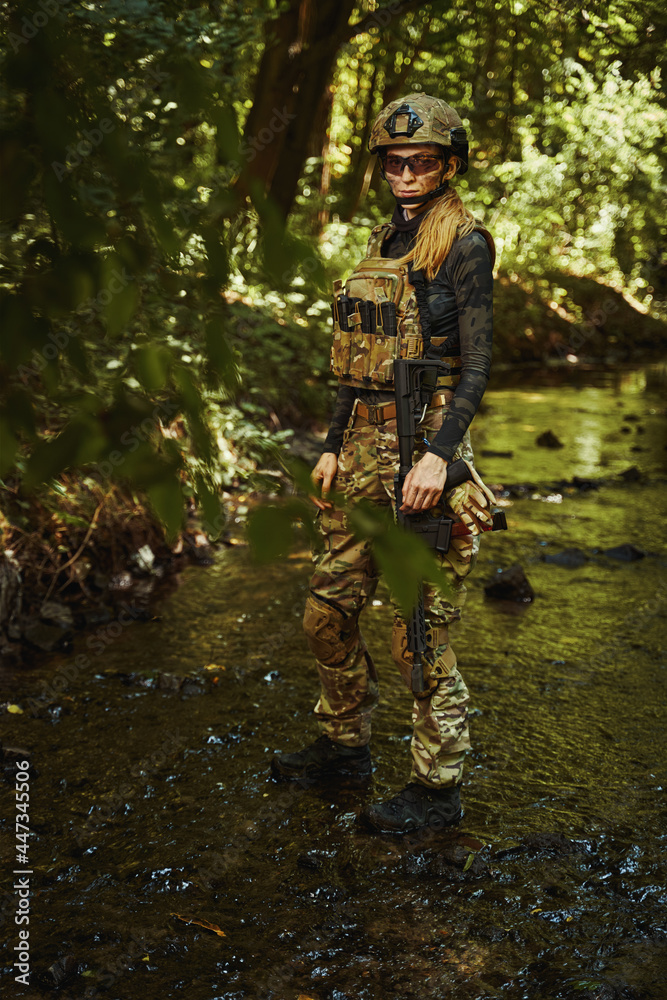 Soldier in camouflage grouping walking through reservoir