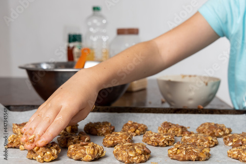 Liittle girl hands preparing oatmeal chocolate chips cookies