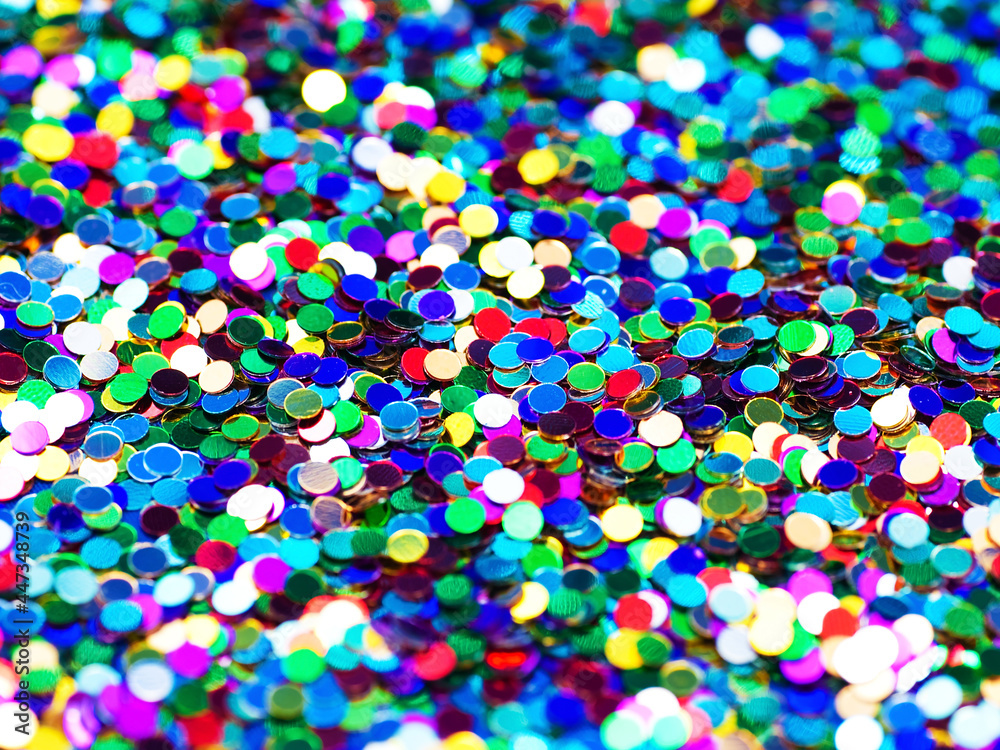 Multicolored festive foil confetti background, close-up