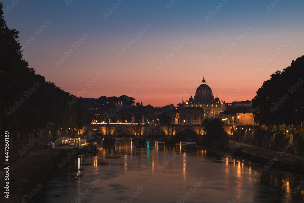 Sunset view of Vatican city and saint peter's basilica over angelo bridge