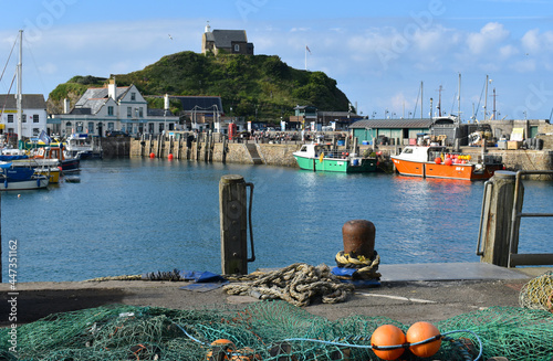 Fishing nets and England's oldest working lighthouse the Chapel of St Nicholas atop Lantern Hill in Ilfracombe. Along the Quay there are restaurants cafes tea gardens pubs with lots of outside seating photo