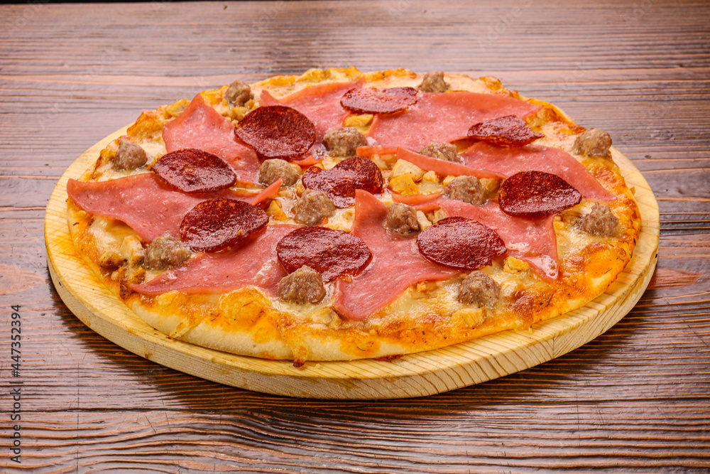 Pizza with ham and pepperoni