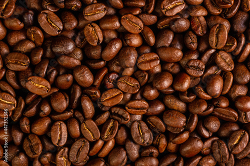 Natural background for Cafe menu or brochure template - macro photo of brown roasted coffee beans, close up © Wingedbull