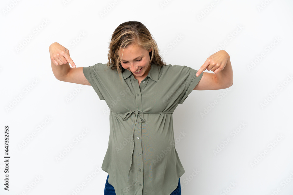 Young caucasian woman isolated on white background pregnant and pointing to the belly
