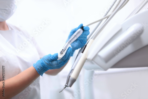 Disinfection of dental equipment. Doctor s assistant wipes equipment in a dental clinic. Dental movable console. Health care concept. Unrecognizable person.