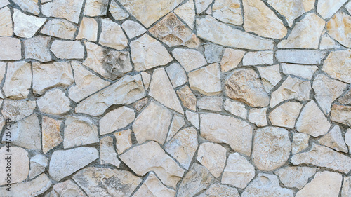 stone wall made of sandstone blocks of different sizes as the background