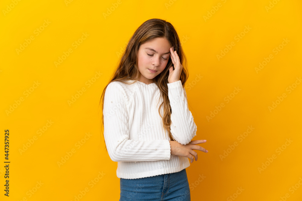 Child over isolated yellow background with headache Child over isolated yellow background with headache
