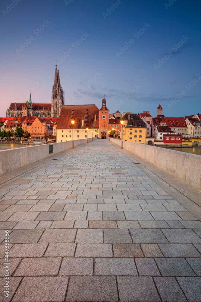 Regensburg, Germany. Cityscape image of Regensburg, Germany with Old Stone Bridge over Danube River and St. Peter Cathedral at summer sunrise.