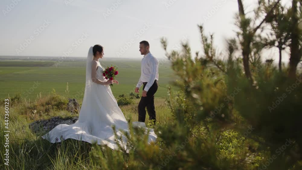 Beautiful bride waits for her groom, holds red bouquet Beautiful bride waits for her groom, holds red bouquet