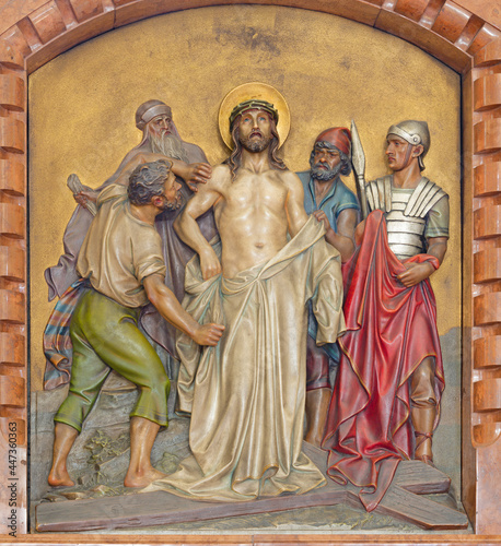 VIENNA, AUSTIRA - JUNI 18, 2021: The relief of Jesus clothes are taken away (part of Cross way) in the Herz Jesu church from begin of 20. cent. by Workroom from Munich.