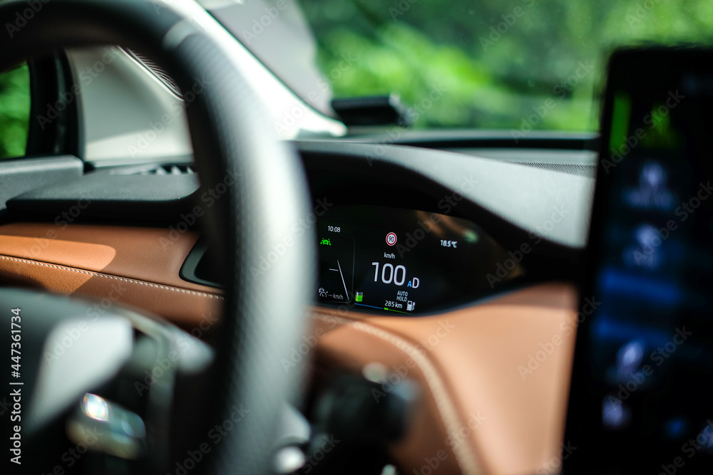 Electric car speedometer dashboard show speed 100 kilometer per hour. Selective focus