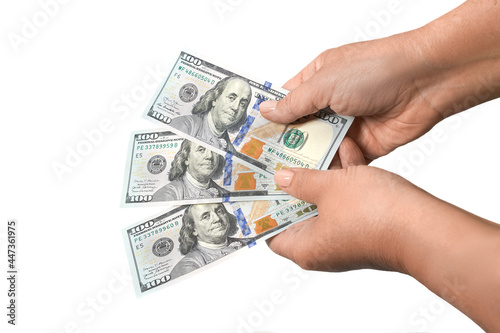 Female hands holding three banknotes of 100 American dollars in cash, isolated on white background