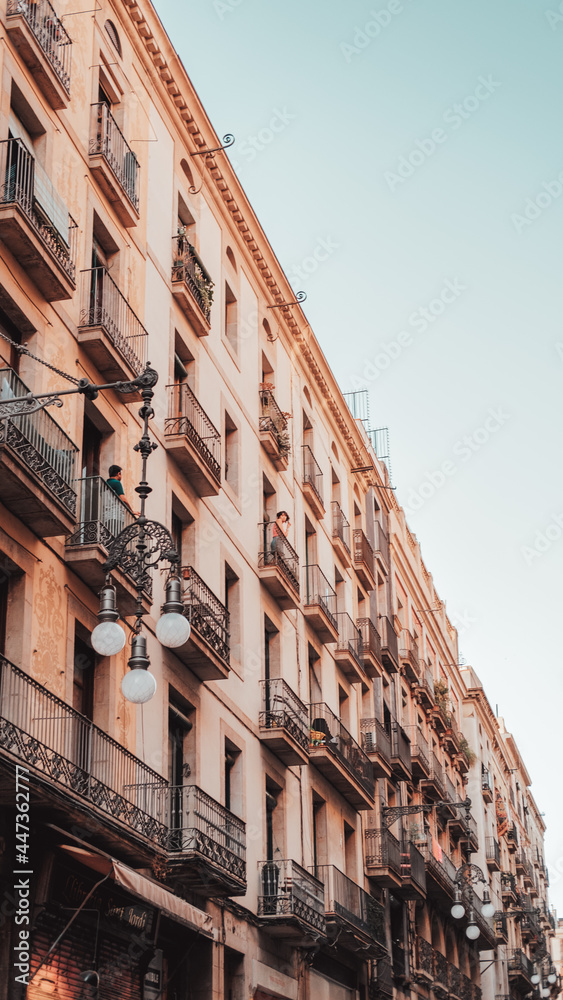 Barcelona, Spain 26-07-2021: a man talks with a girl from their balconies