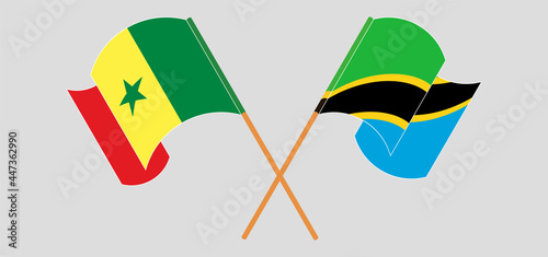 Crossed and waving flags of Senegal and Tanzania
