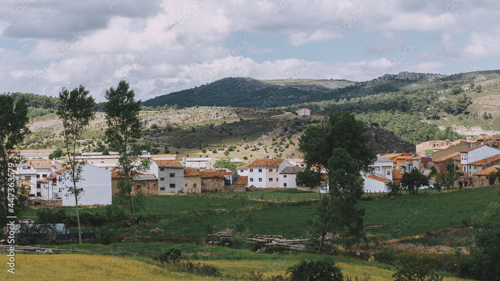 Small mountain village in the Alto Tajo National Park. View of the mountains, houses and gardens.