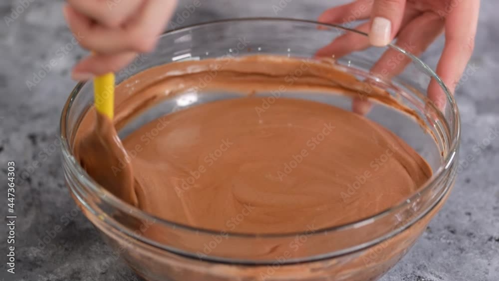 Chocolate mousse being mixed in bowl. Chocolate mousse being mixed in bowl.