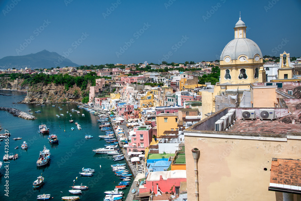 PROCIDA, ITALY - JUNE 22, 2021: Aerial view of La Corricella, colorful homes along the sea.