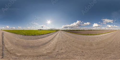no traffic white sand gravel road among fields with clear sky with some clouds in equirectangular projection, VR AR content. Full spherical seamless hdri panorama 360 degrees angle view