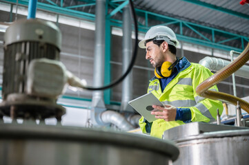 professional inspection control scientist in uniform are working for fruit juice production industry in food manufacturing factory, water drink checking and beverage research in laboratory