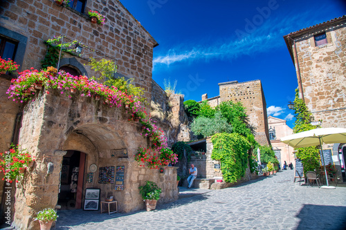 Fototapeta Naklejka Na Ścianę i Meble -  CIVITA DI BAGNOREGIO, ITALY - JULY 2, 2021: Tourists visit famous medieval streets.