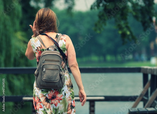 female tourist on the pier on the Gopło lake in Poland photo