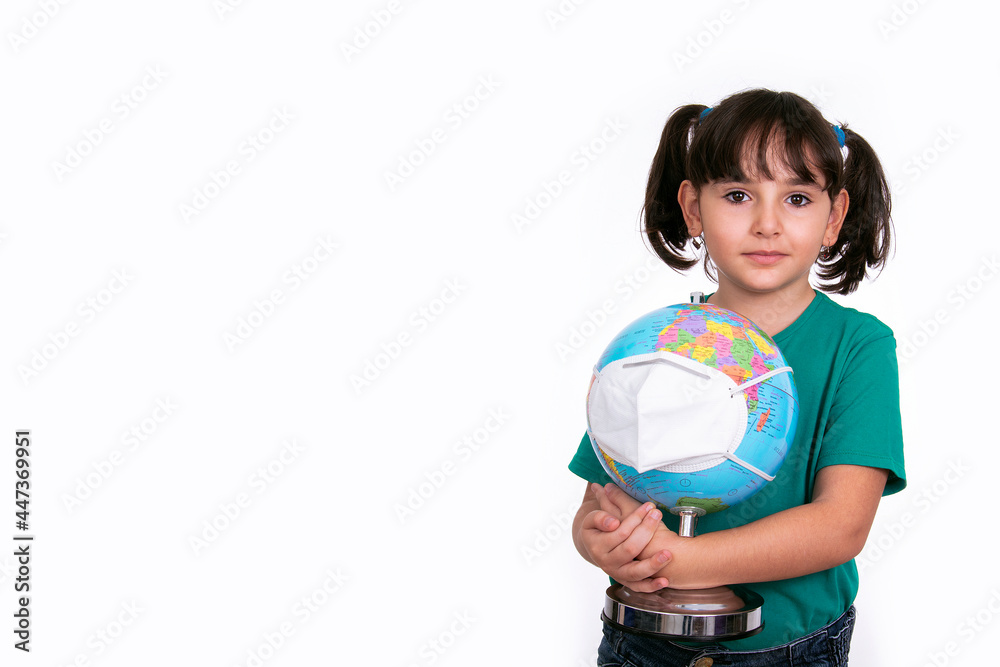 child preschooler girl holds terrestrial globe both with fabric mask protection covid, flu, health care, environment with space for text.