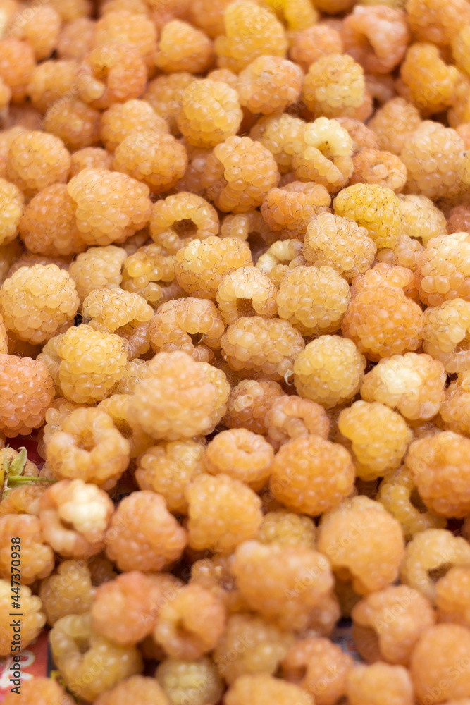 Ripe yellow raspberries, background. Many plucked yellow berries, Summer concept