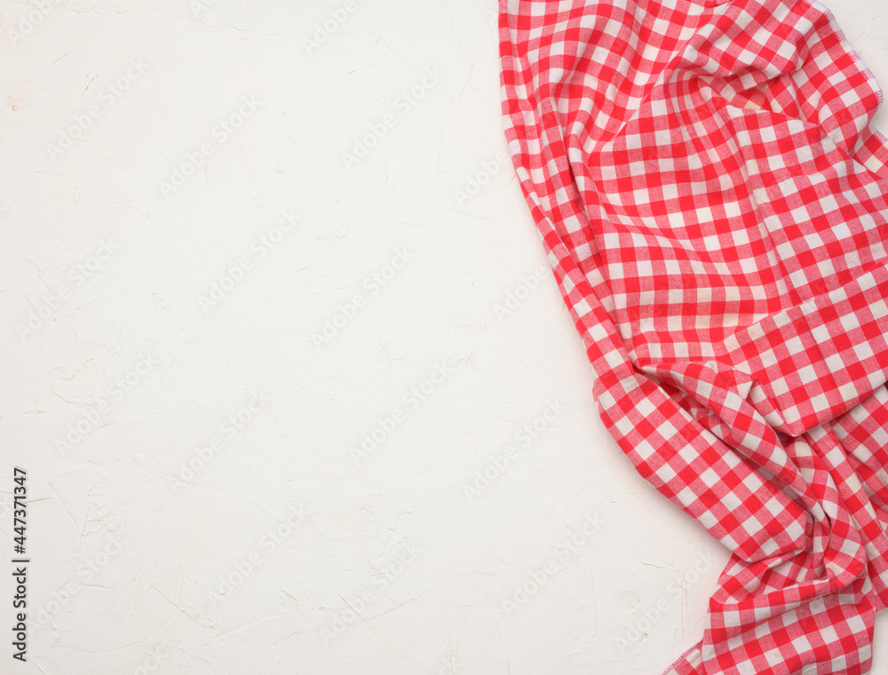 folded cotton red white checkered napkin on a white background folded cotton red white checkered napkin on a white background