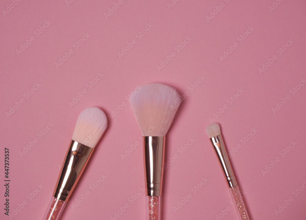 Makeup brushes on pink background flatley Makeup brushes on pink background flatley