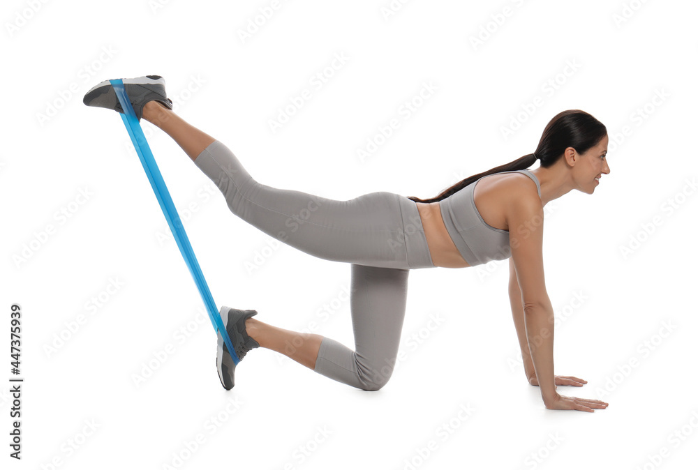 Obraz premium Woman doing sportive exercise with fitness elastic band on white background