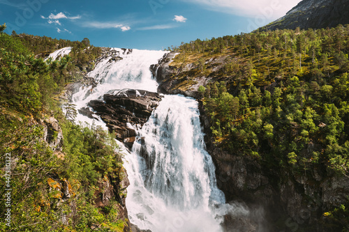 Kinsarvik, Hordaland, Norway. Waterfall Nyastolfossen In Hardangervidda Mountain Plateau. Nyastolsfossen in Spring Sunny Day. Height Of 115 m. Norwegian Landmark And Popular Destination