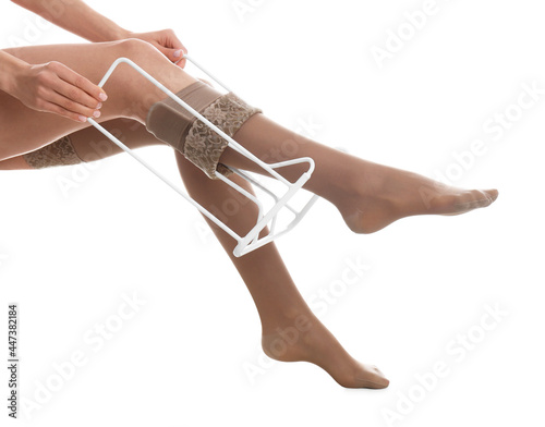 Woman wearing compression tights with donner on white background, closeup