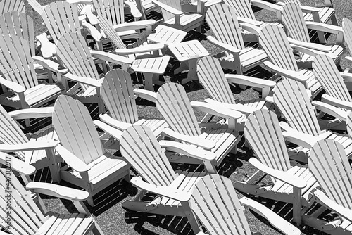 large collection of bright white seaside lodge hotel deck chairs beach chair group