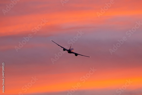 Twin jet taking off into the sunset © David S. Swierczek