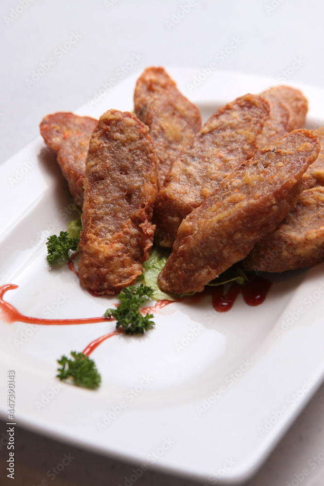 deep fried wu xiang pork meat roll with sauces in white background fusion asian halal menu deep fried wu xiang pork meat roll with sauces in white background fusion asian halal menu