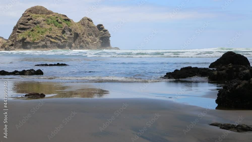 Surfer on Piha beach - New Zealand Surfer on Piha beach - New Zealand