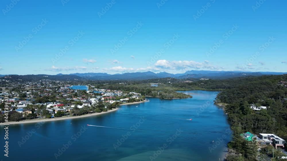 Scenic panoramic view of a large inland river system with mountain peaks in the distance. High moving drone view Scenic panoramic view of a large inland river system with mountain peaks in the distance. High moving drone view