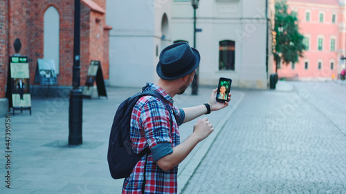 Back view of tourist making video call with female tourist from other place. They exchanging impressions from travelings. photo