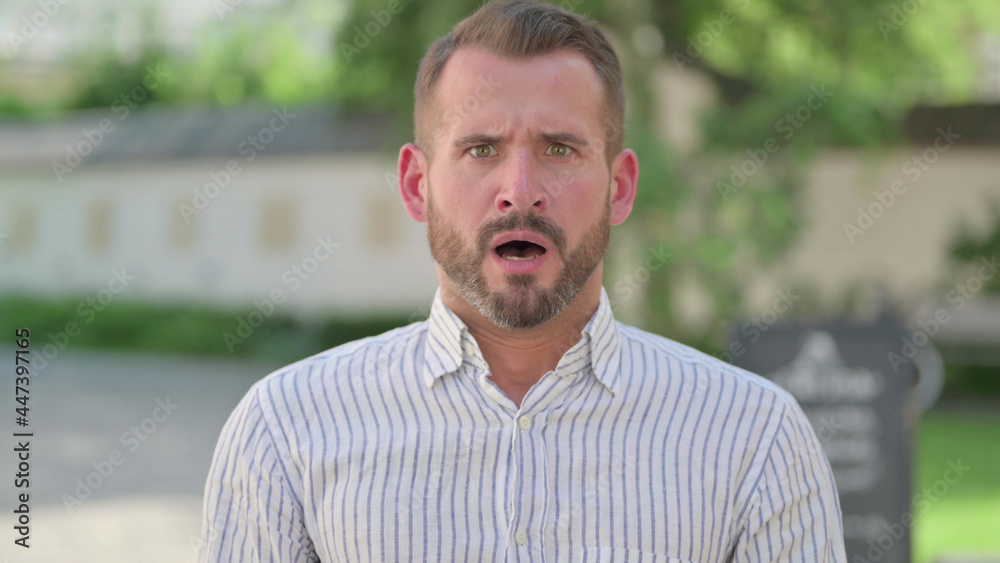 Outdoor Portrait of Disappointed Mature Adult Man Reacting Loss Outdoor Portrait of Disappointed Mature Adult Man Reacting Loss