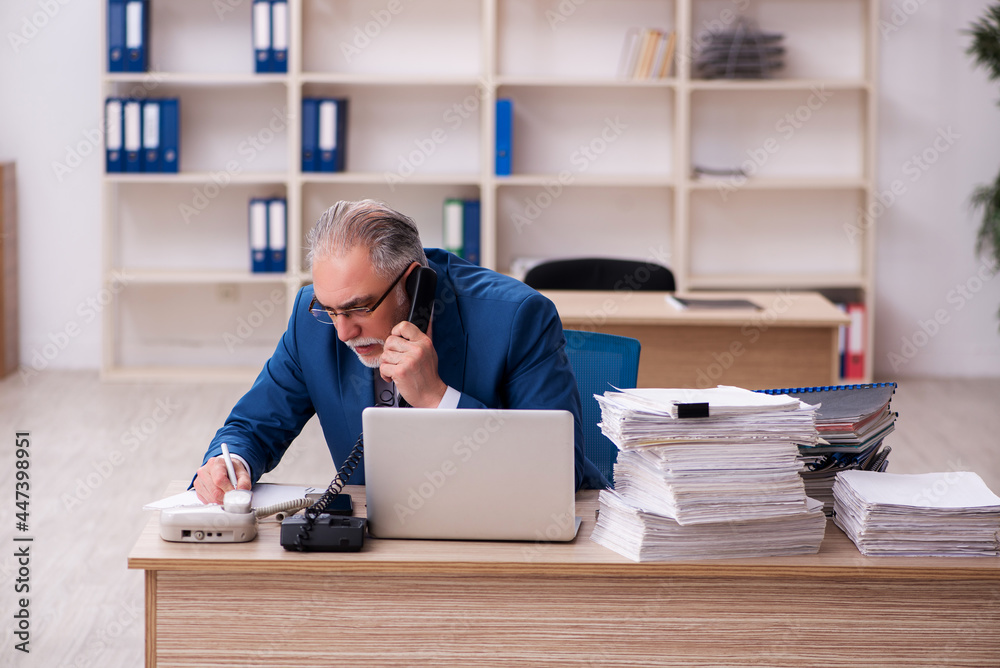 Old male employee and too much work in the office Old male employee and too much work in the office