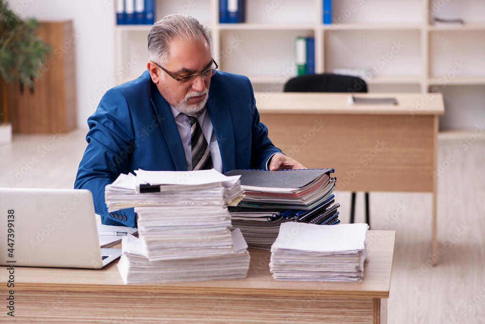 Old male employee and too much work in the office Old male employee and too much work in the office