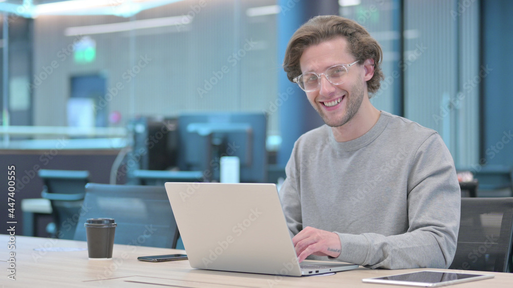 Young Man with Laptop Smiling at Camera Young Man with Laptop Smiling at Camera
