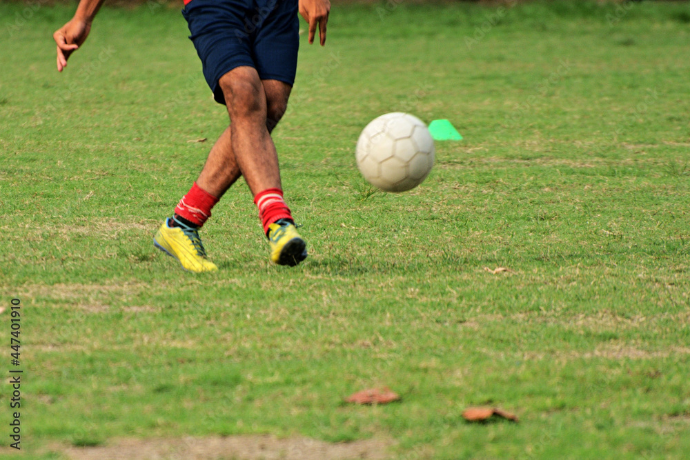 Close-up of soccer player kick soccer ball on soccer pitch. Close-up of soccer player kick soccer ball on soccer pitch.