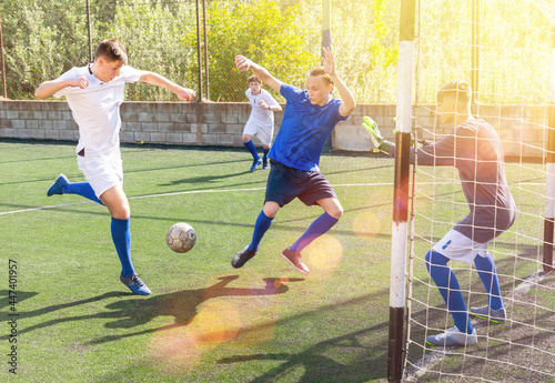 Young football players fighting for ball in goalmouth zone © JackF