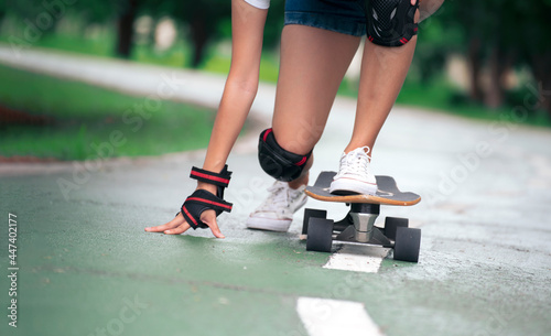 Attractive female teenager resting with a longboardskate . Sport activity lifestyle concept, Healthy and exercise.