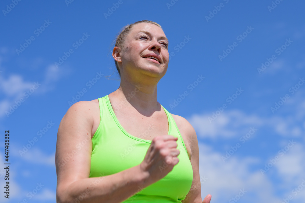 Low angle close up of an overweight woman jogging Low angle close up of an overweight woman jogging