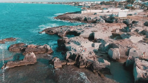 Tourists At The Ruins Of Coastal Watchtower In Calette Di Torre Cintola In Bari City, Italy. aerial photo