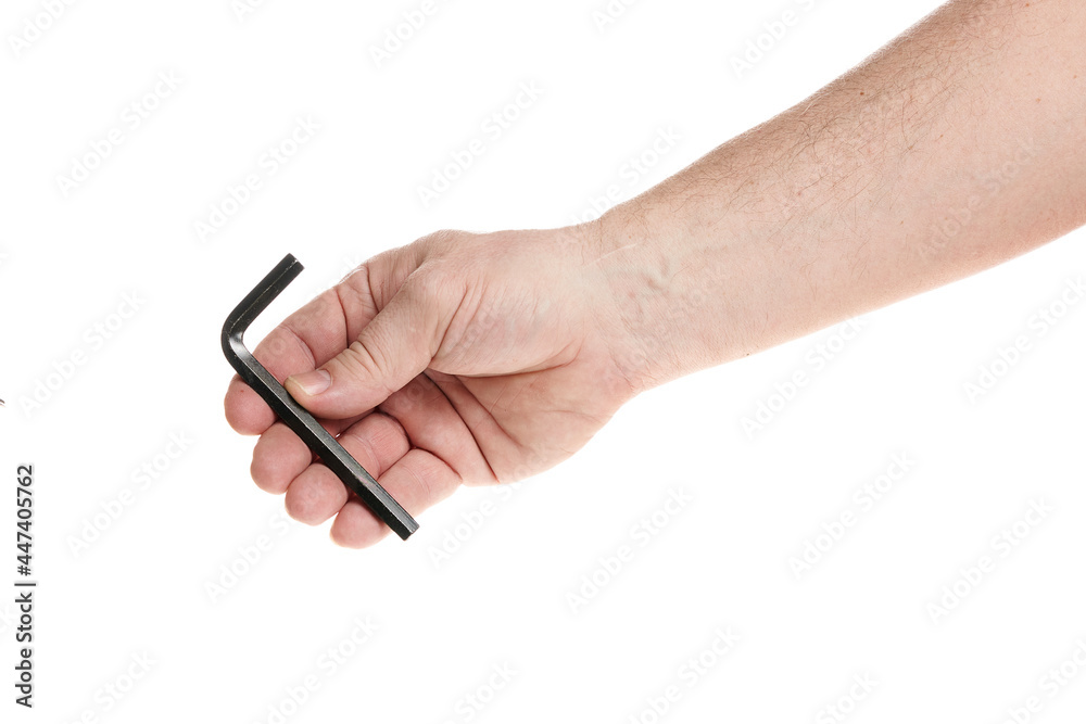 Hand holds a black hex key on a white background, a template for designers. Hand holds a black hex key on a white background, a template for designers.
