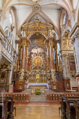 VIENNA, AUSTIRA - JULI 5, 2021: The presbytery and main altar of broque church Franziskanerkirche by Andrea Pozzo (1707).